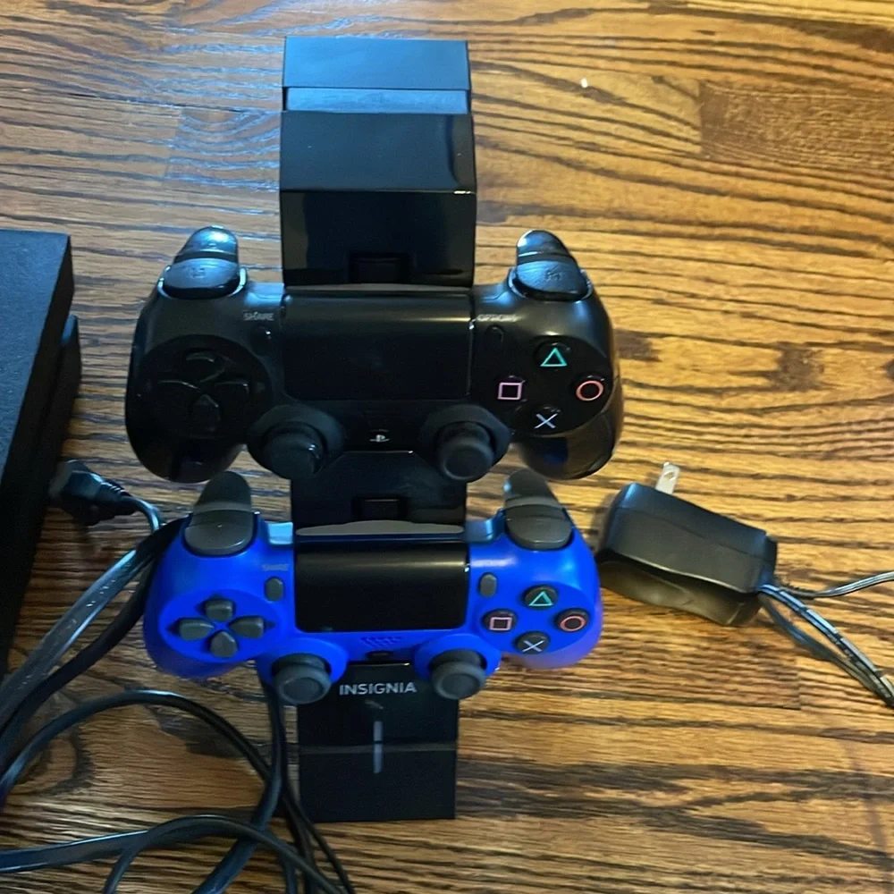 PS4 Console with dual controllers, controller charging station with 16 PS4 games